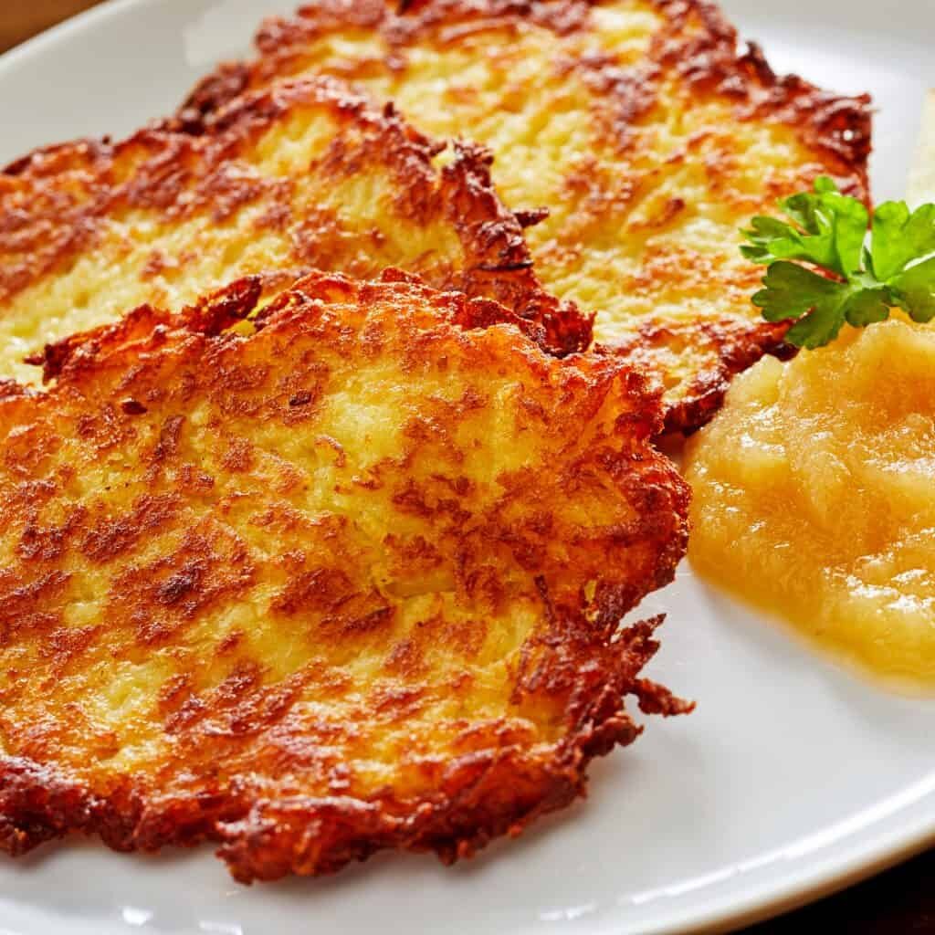 Crispy golden Kartoffelpuffer – the iconic potato pancake of German cuisine. (Source: daringgourmet.com)