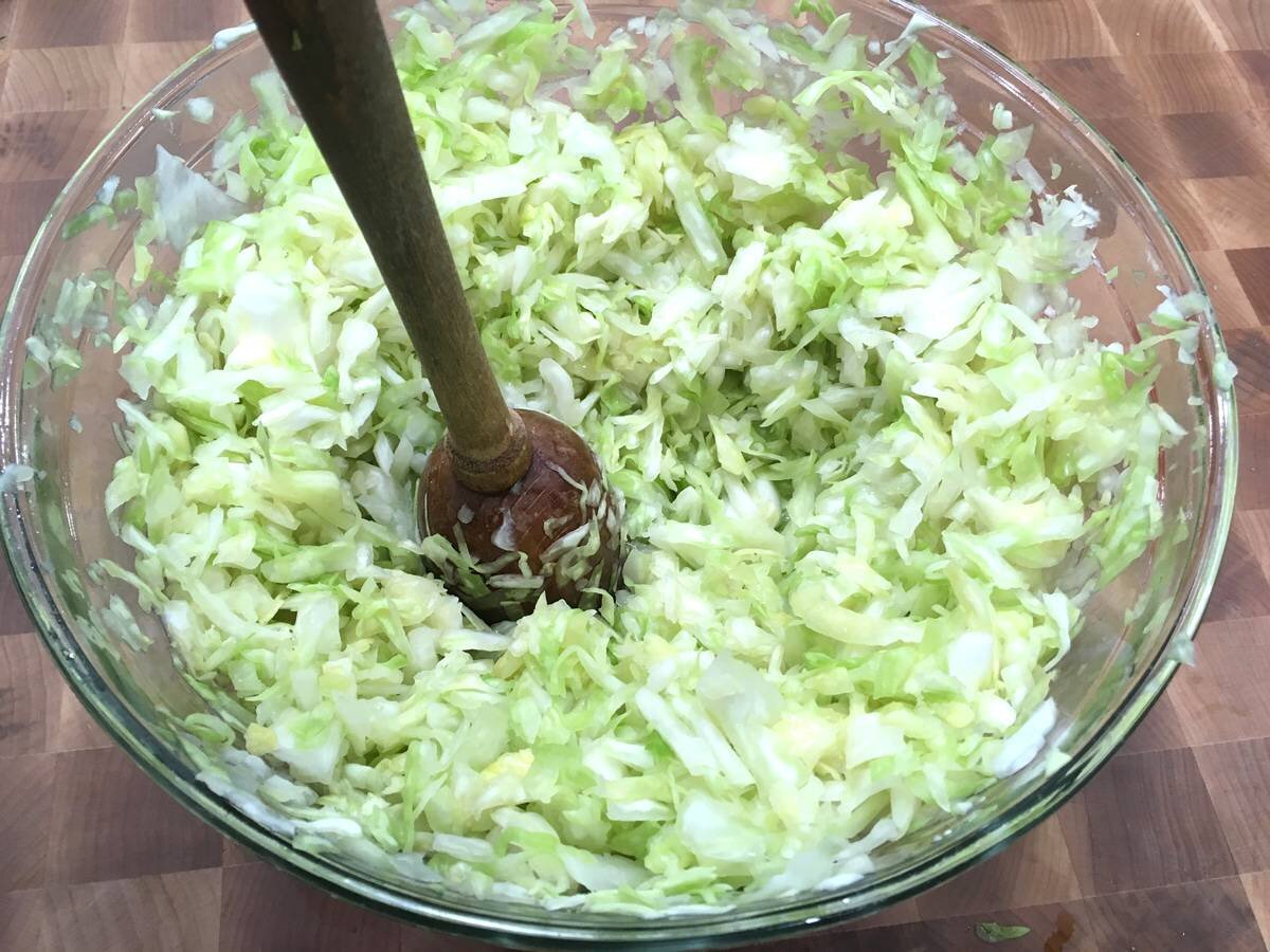 Mixing salt and kneading the cabbage. (Source: daringgourmet.com)
