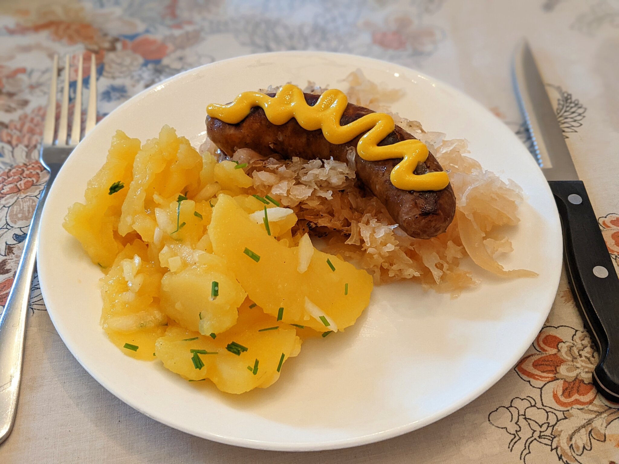 Potato salad served with grilled bratwurst